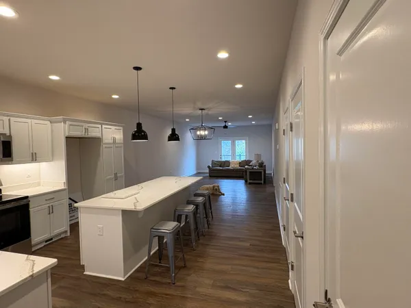 a large kitchen with a table and chairs