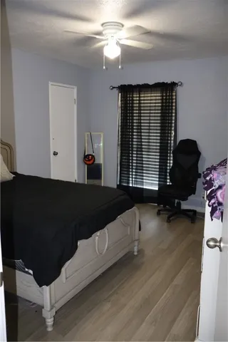 a living room with a bed furniture and a window