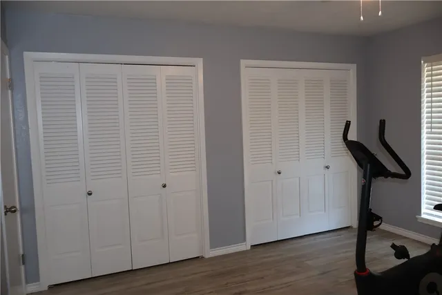 a view of a room with wooden floor and windows