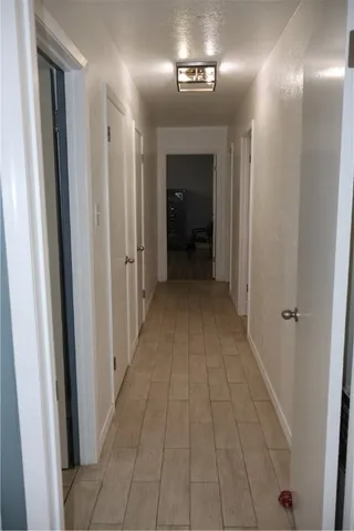 a view of a hallway with wooden floor