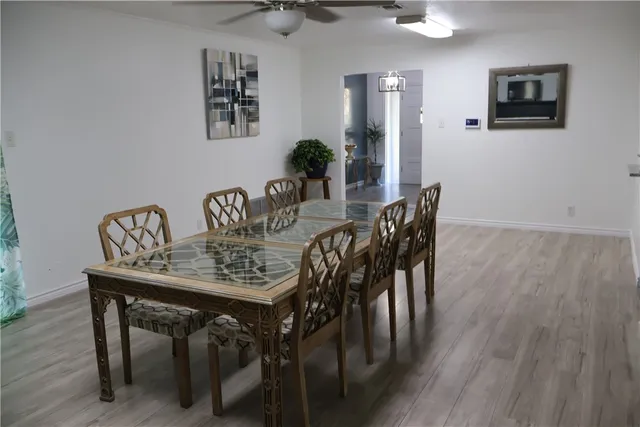 a view of a dining room with furniture and wooden floor