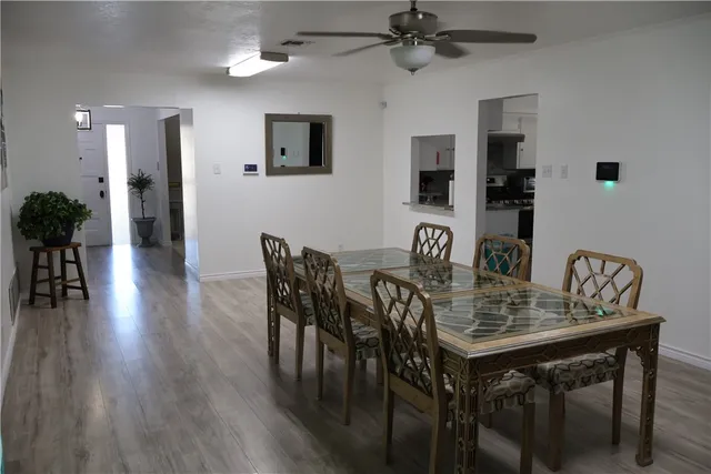 a view of a a dining room with furniture window and wooden floor