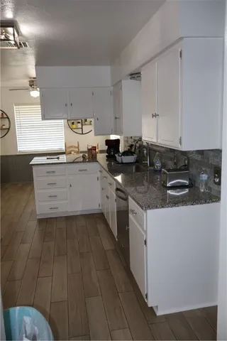 a kitchen with stainless steel appliances granite countertop a sink stove and cabinets