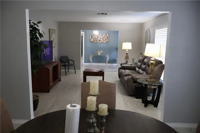 a living room with furniture and wooden floor