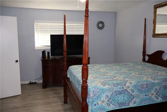 a bedroom with a bed and a flat tv screen