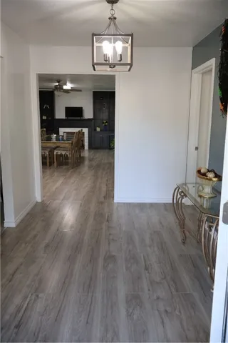 a view of a room with wooden floor furniture and windows