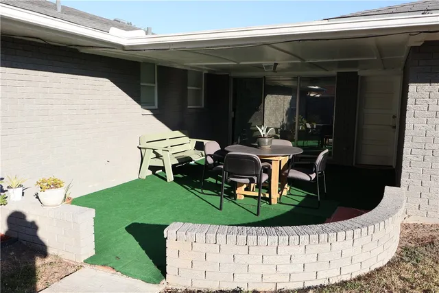 a view of a chair and tables in the patio