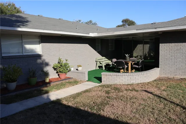 a front view of a house with potted plants