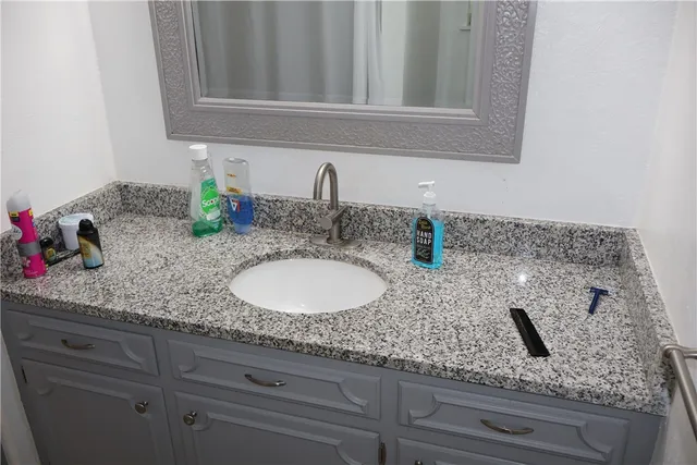 a bathroom with sink and mirror