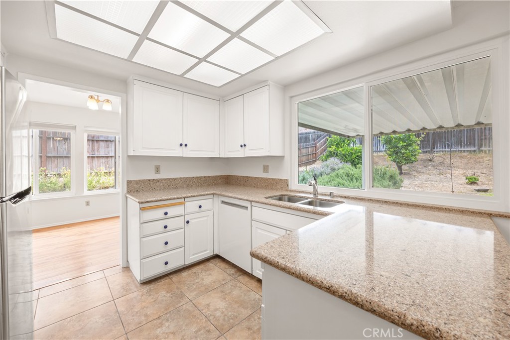 3430 Bahia Place Riverside, CA 92507 - Photo 18 of 34 a kitchen with granite countertop white cabinets and white appliances