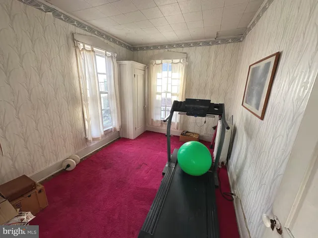 a view of a hallway with chair and front door