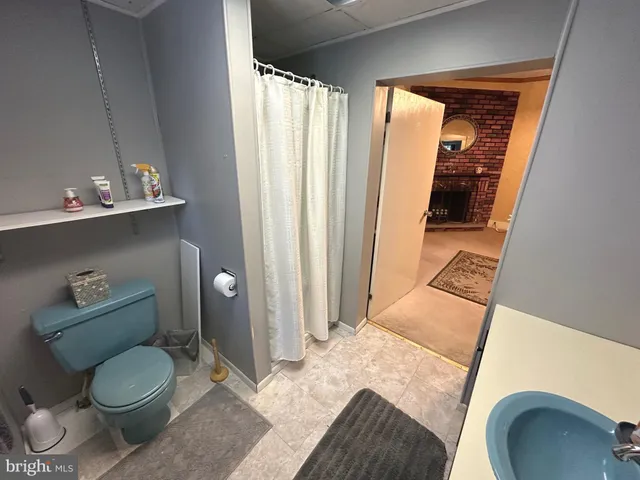 a bathroom with a sink mirror and window