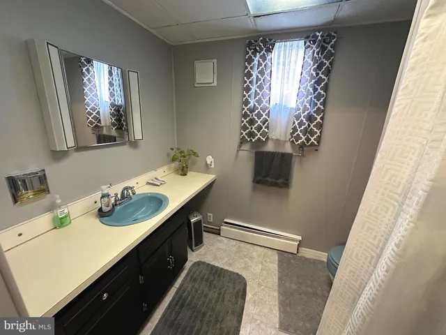 a living room with furniture rug and a window