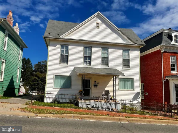a front view of a house with garage and glass windows