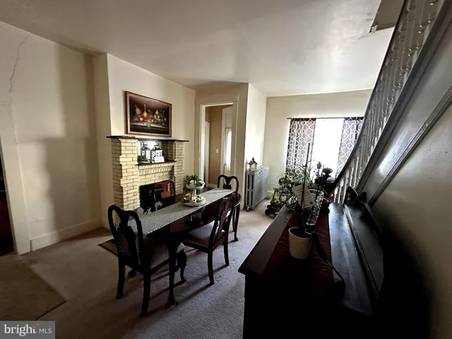 a dining room with furniture and wooden floor