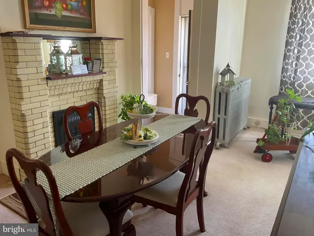 a dining room with furniture and potted plants