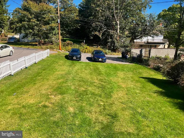 a front view of a house with swimming pool and sitting area