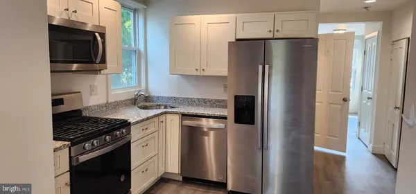 a kitchen with stainless steel appliances a refrigerator stove and sink
