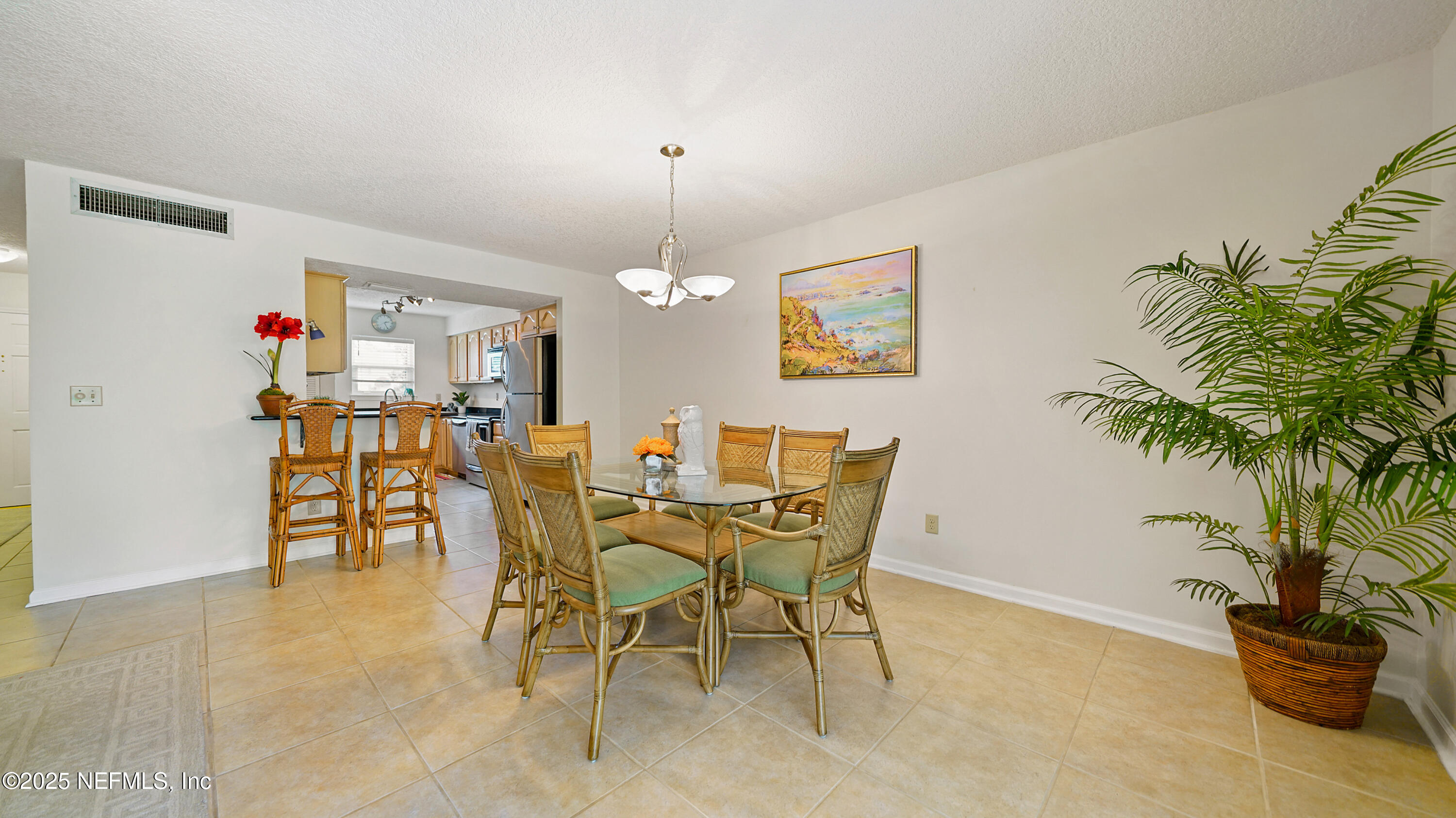 2233 Seminole Road, Unit 7 Atlantic Beach, FL 32233 - Photo 11 of 52 a view of a dining room with furniture and chandelier
