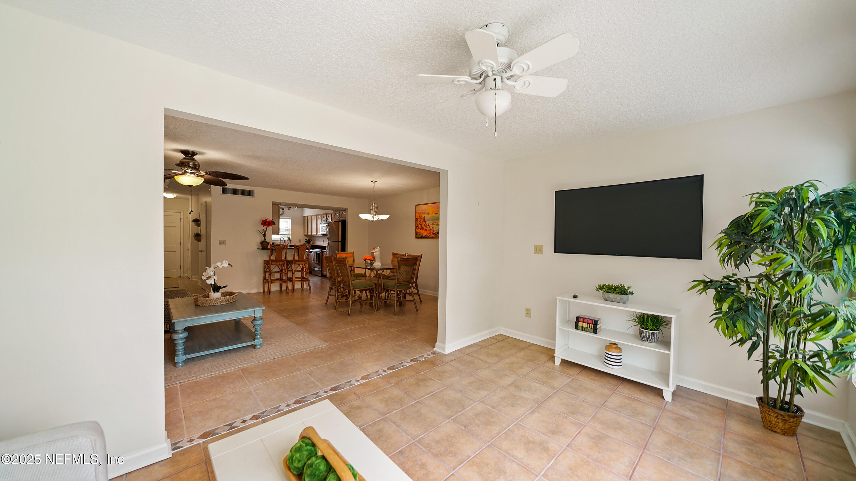 2233 Seminole Road, Unit 7 Atlantic Beach, FL 32233 - Photo 13 of 52 a living room with furniture and a flat screen tv