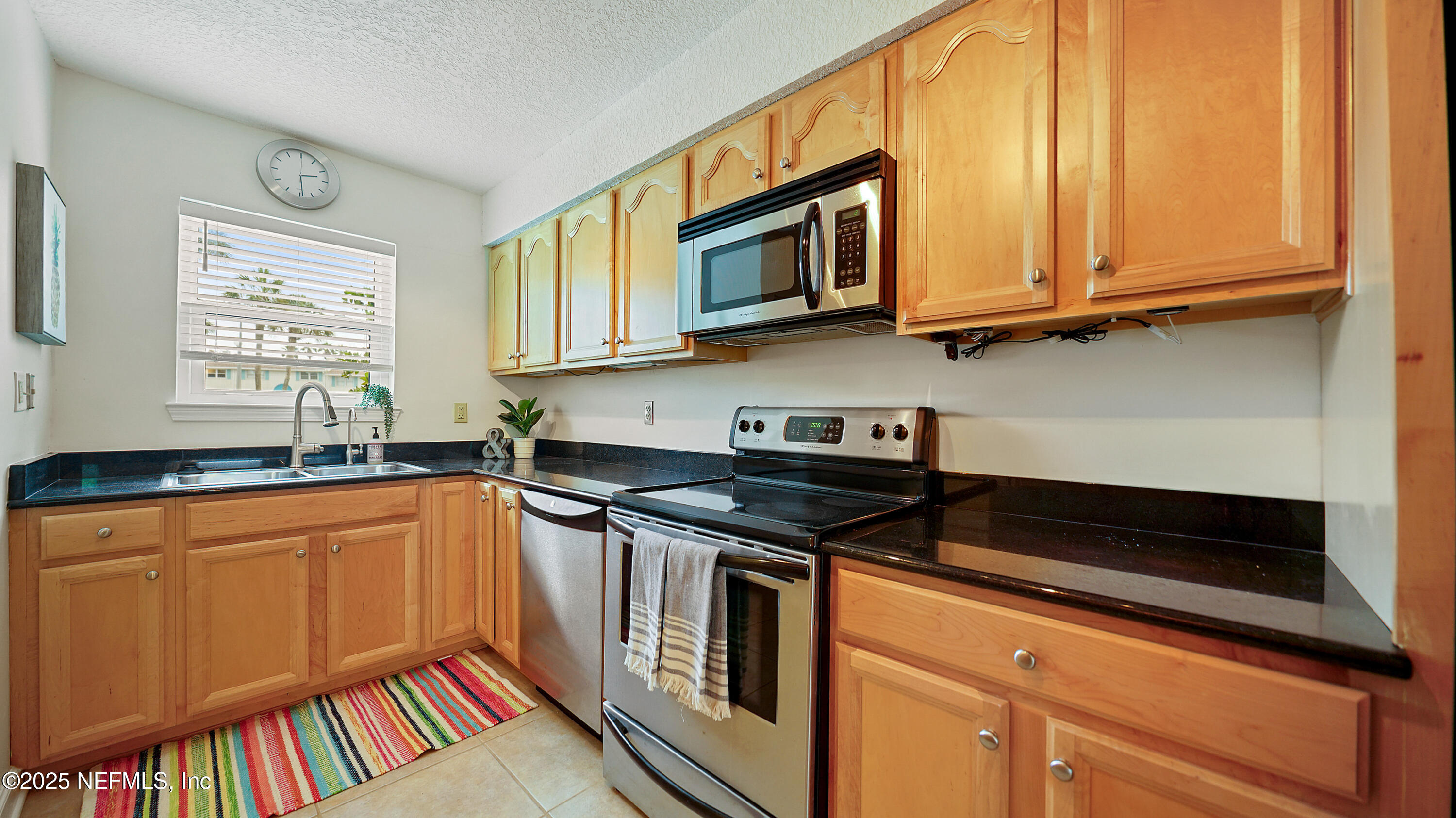 2233 Seminole Road, Unit 7 Atlantic Beach, FL 32233 - Photo 14 of 52 a kitchen with stainless steel appliances granite countertop a stove and a microwave