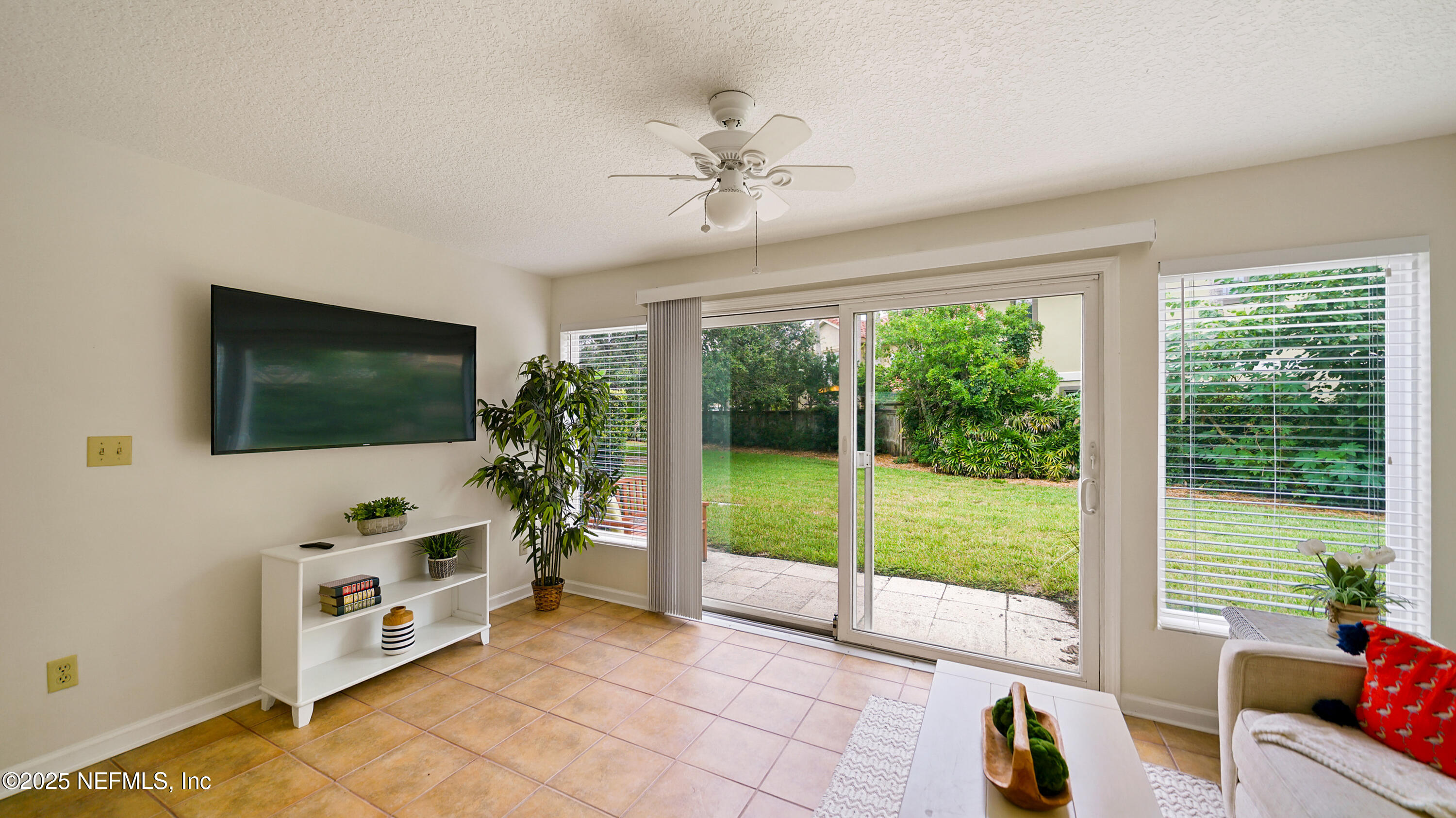 2233 Seminole Road, Unit 7 Atlantic Beach, FL 32233 - Photo 16 of 52 a living room with furniture and a flat screen tv