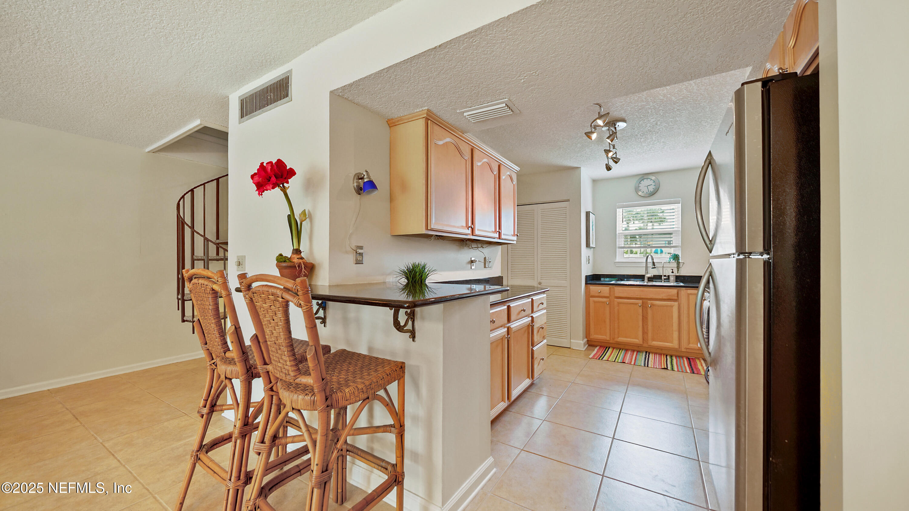 2233 Seminole Road, Unit 7 Atlantic Beach, FL 32233 - Photo 23 of 52 a kitchen with stainless steel appliances granite countertop a sink and a refrigerator