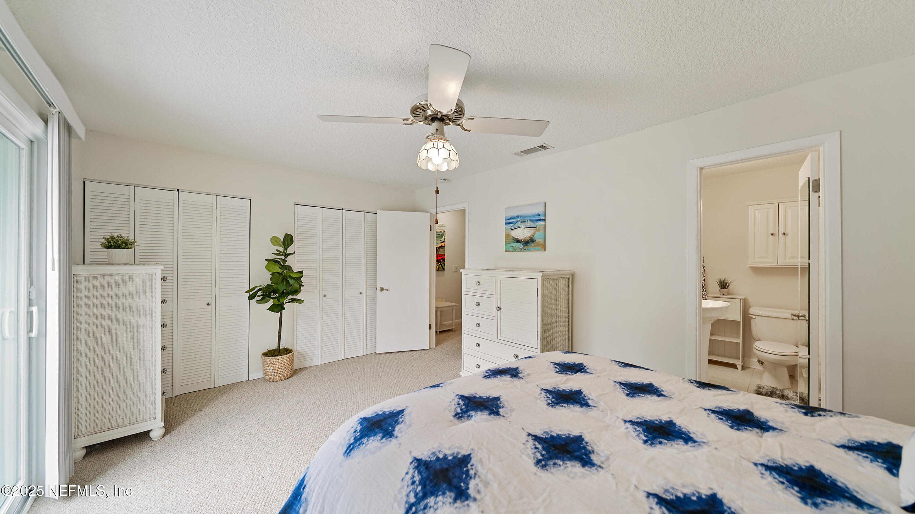 2233 Seminole Road, Unit 7 Atlantic Beach, FL 32233 - Photo 27 of 52 a bedroom with a bed and a chandelier