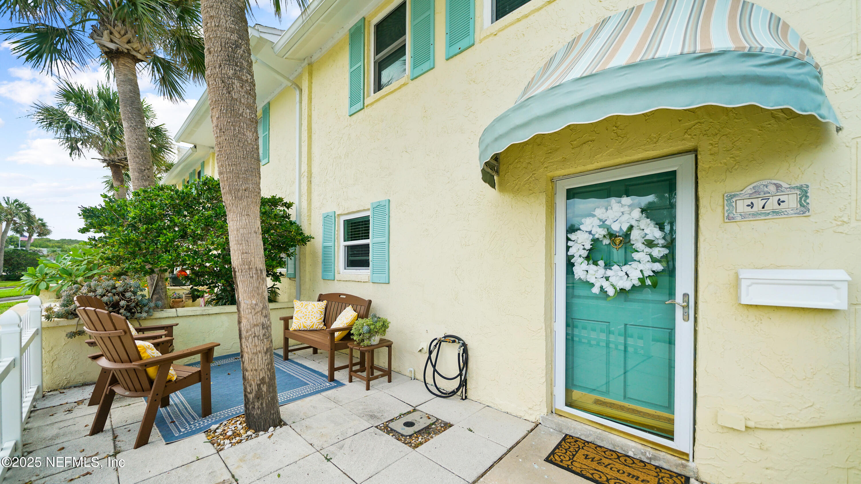 2233 Seminole Road, Unit 7 Atlantic Beach, FL 32233 - Photo 7 of 52 a view of backyard with a table and chairs under an umbrella