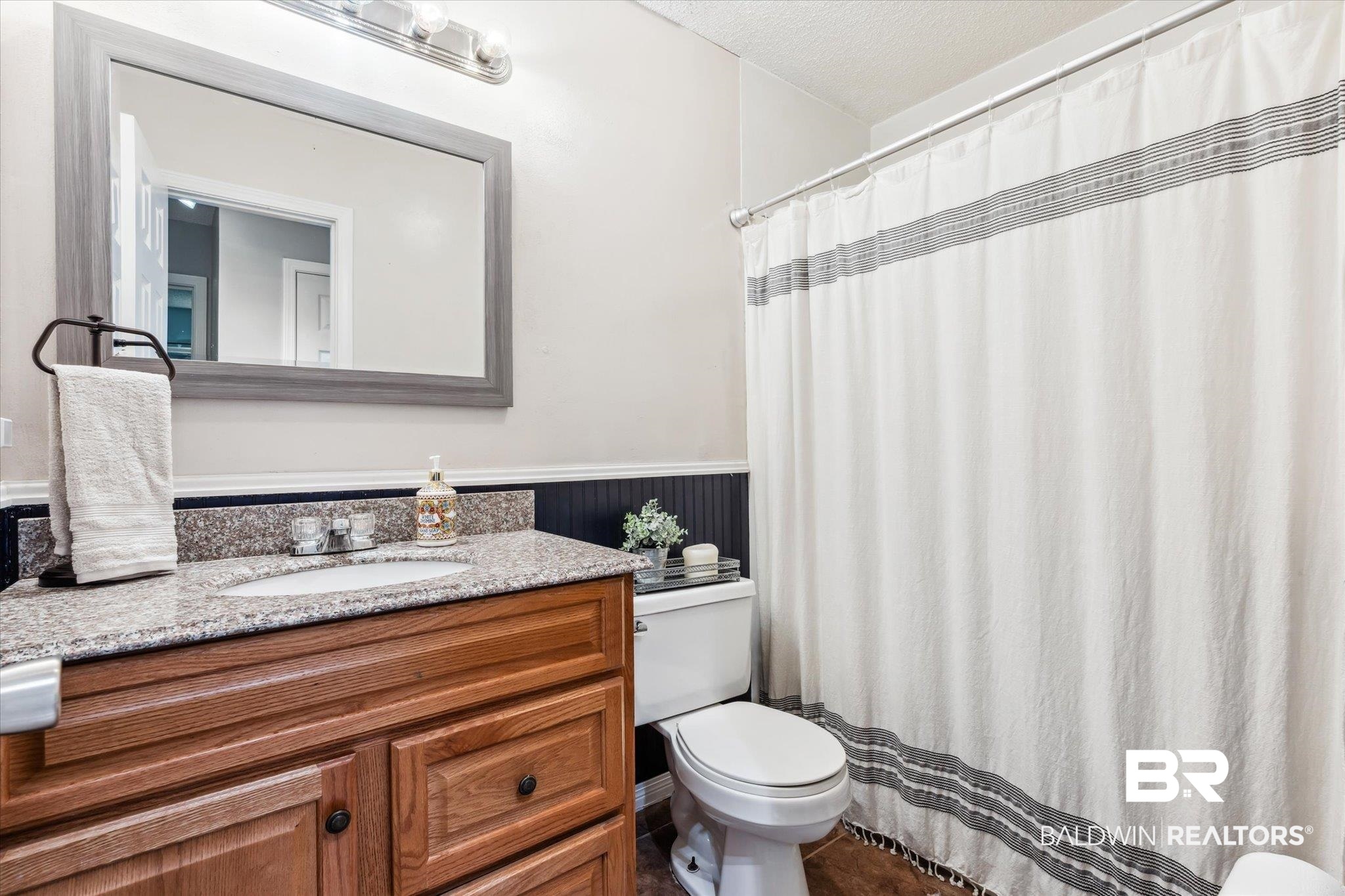 9306 Prairie Drive Semmes, AL 36575 - Photo 12 of 20 Bathroom with tile patterned floors, toilet, vanity, and a textured ceiling