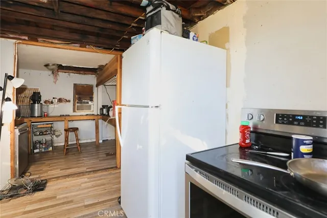 a kitchen with a stove and a refrigerator