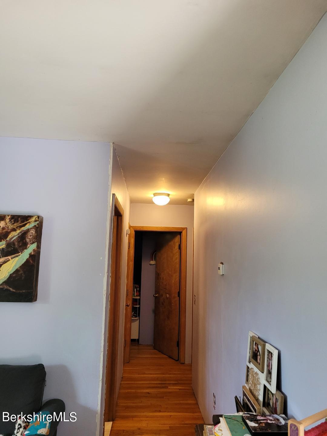 16 West Main Road Peru, MA 01235 - Photo 10 of 15 a view of a hallway with wooden floor and closet
