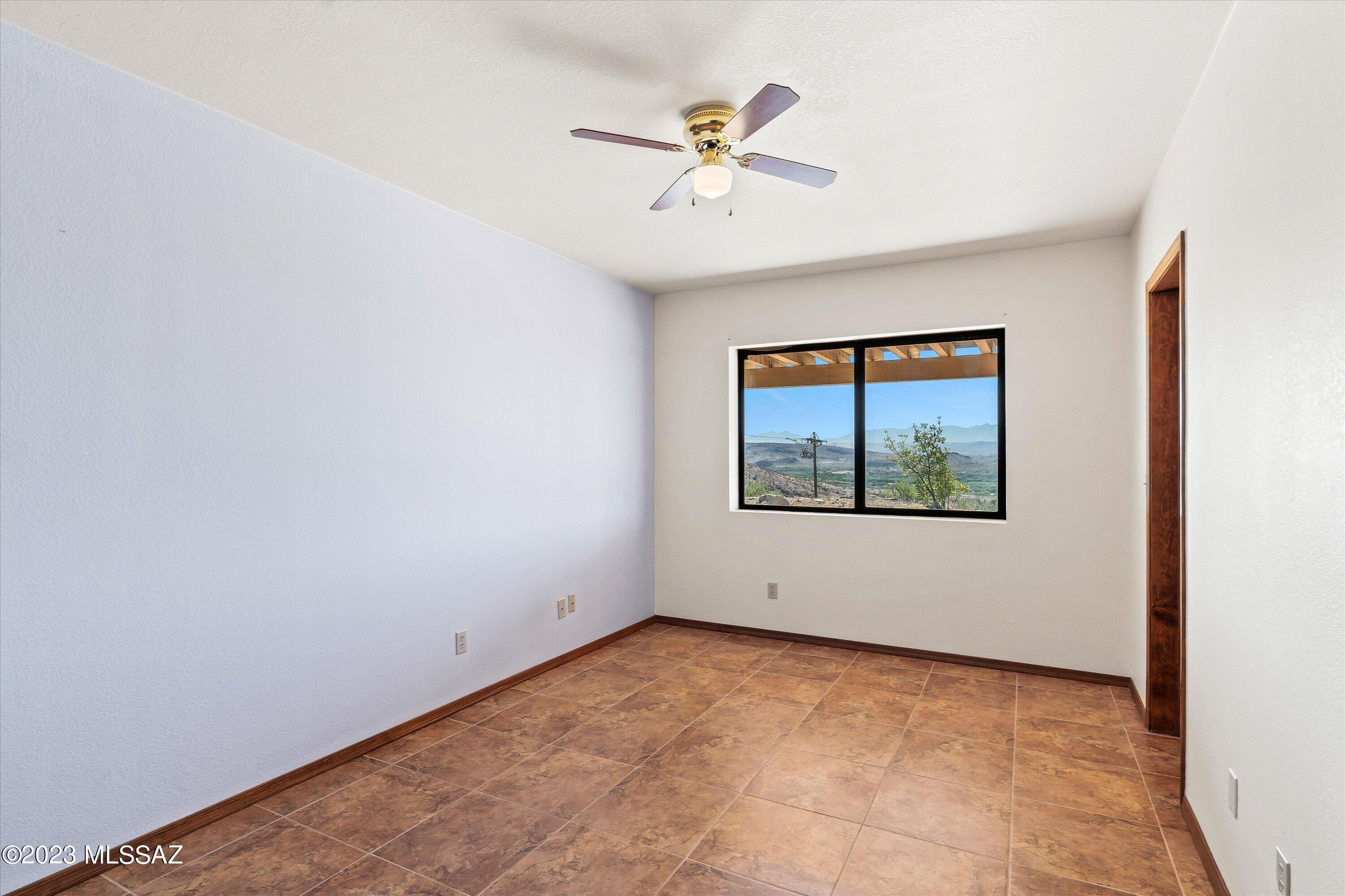 1226 Avenida Gloriosa Rio Rico, AZ 85648 - Photo 18 of 46 a view of an empty room with a window