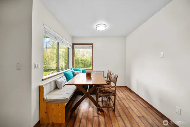 a view of a dining room with furniture and a window