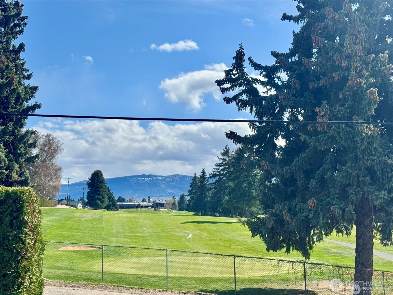 225 19th Street Northeast, Unit 23 East Wenatchee, WA 98802 - Photo 5 of 40 a view of a bench in front of a house