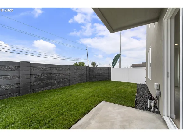 a view of a backyard with wooden fence