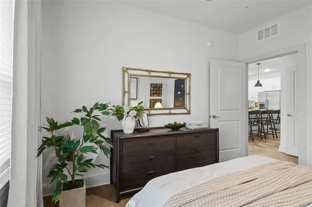 a bedroom with a sink and a mirror