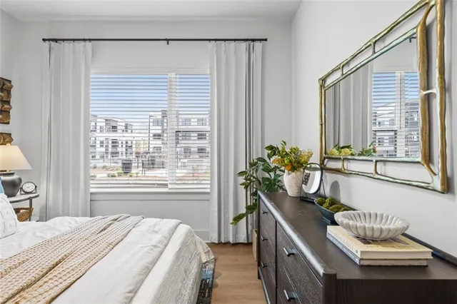 a bedroom with a bed and a potted plant