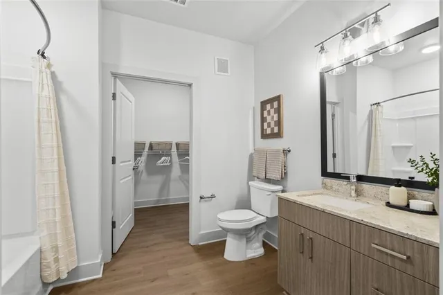 a bathroom with a toilet sink and shower