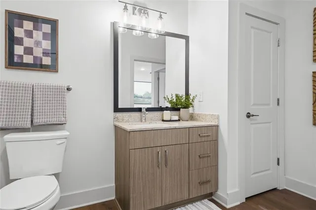a bathroom with a toilet a sink and mirror