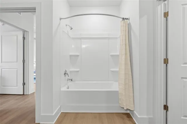 a bathroom with a tub and shower