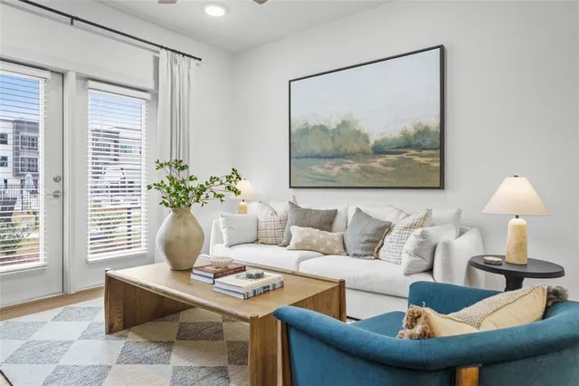 a living room with furniture and a potted plant