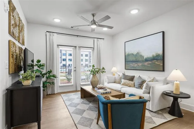 a living room with furniture and a potted plant