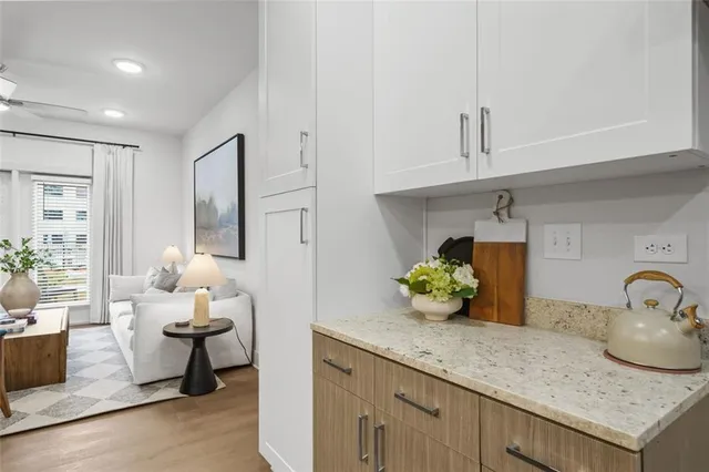 a kitchen with a sink and white cabinets