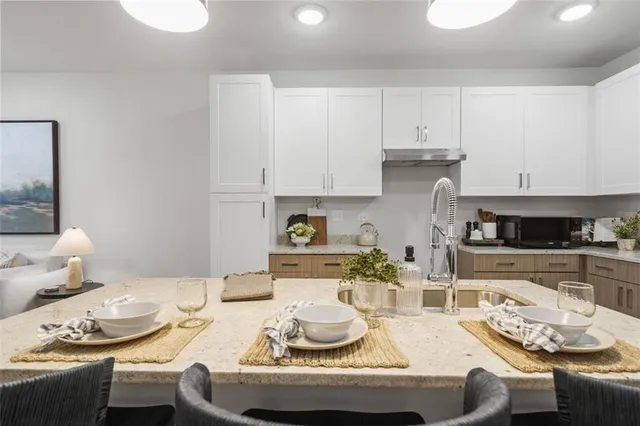 a kitchen with a dining table and chairs