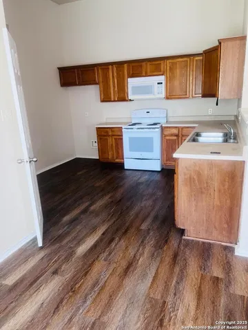 a kitchen with wooden floors and a sink