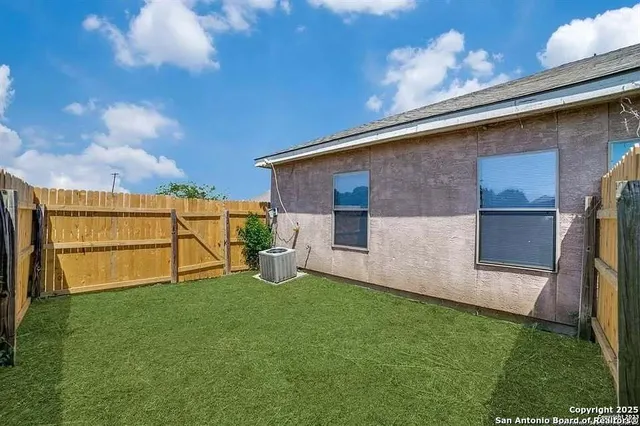 a view of a backyard with potted plants