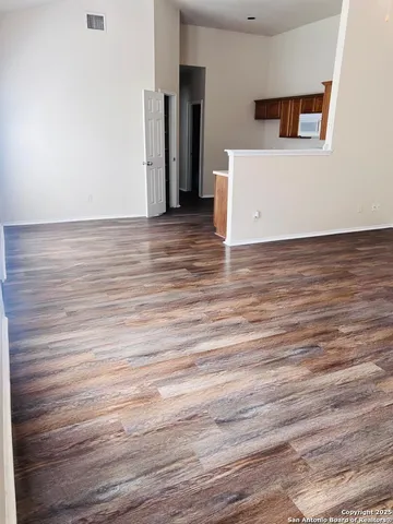 a view of a room with wooden floor