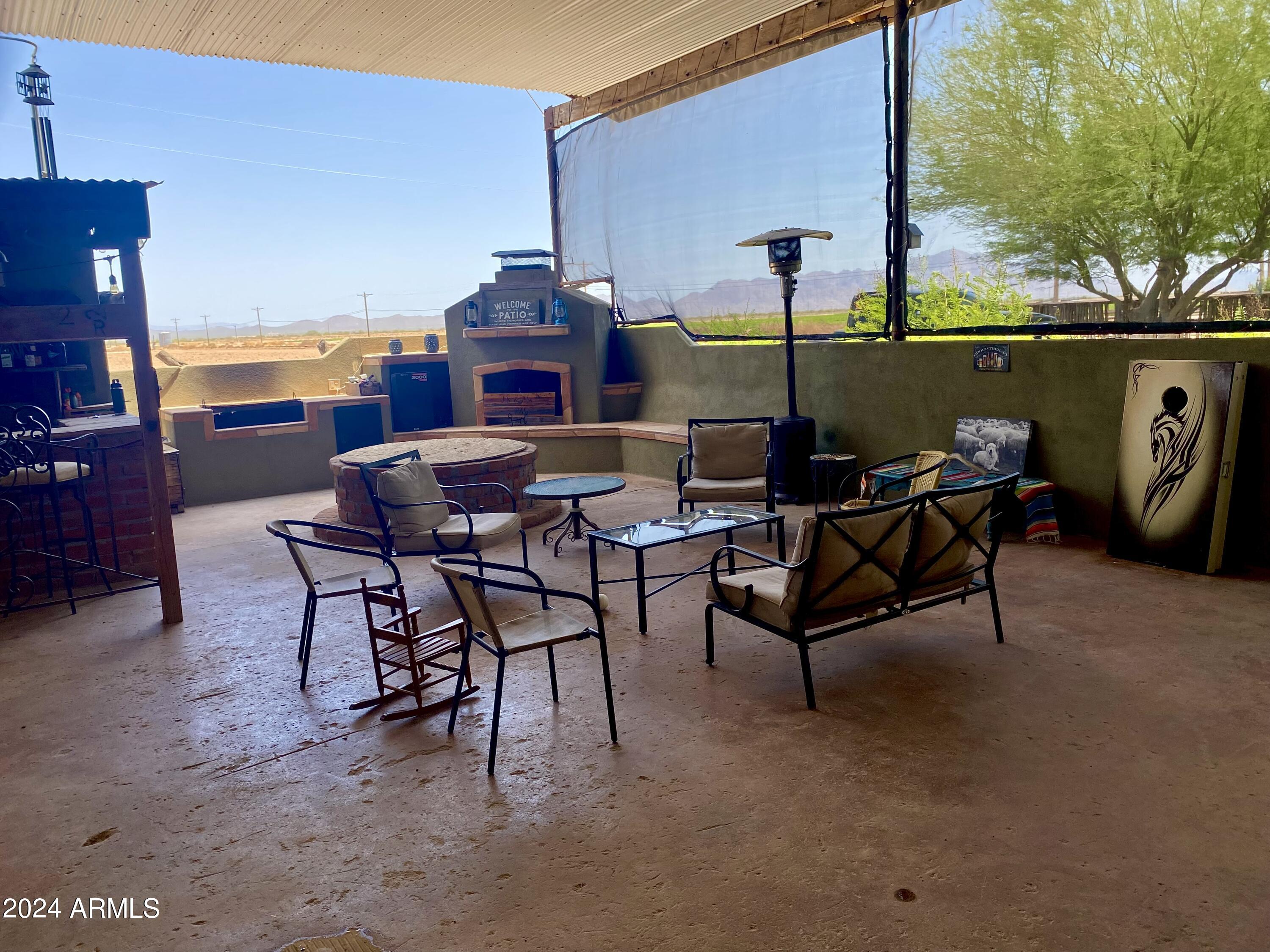 642 East Cornman Road Coolidge, AZ 85128 - Photo 16 of 64 a view of a patio with table and chairs and potted plants
