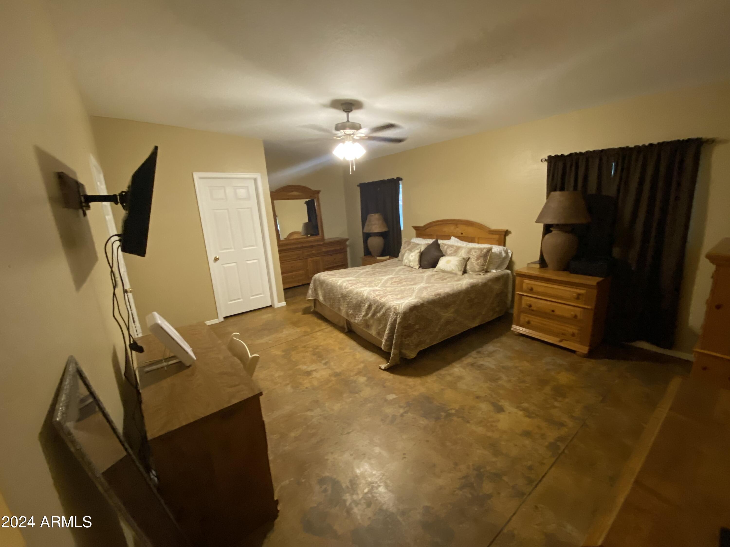 642 East Cornman Road Coolidge, AZ 85128 - Photo 18 of 64 a bedroom with bed and window